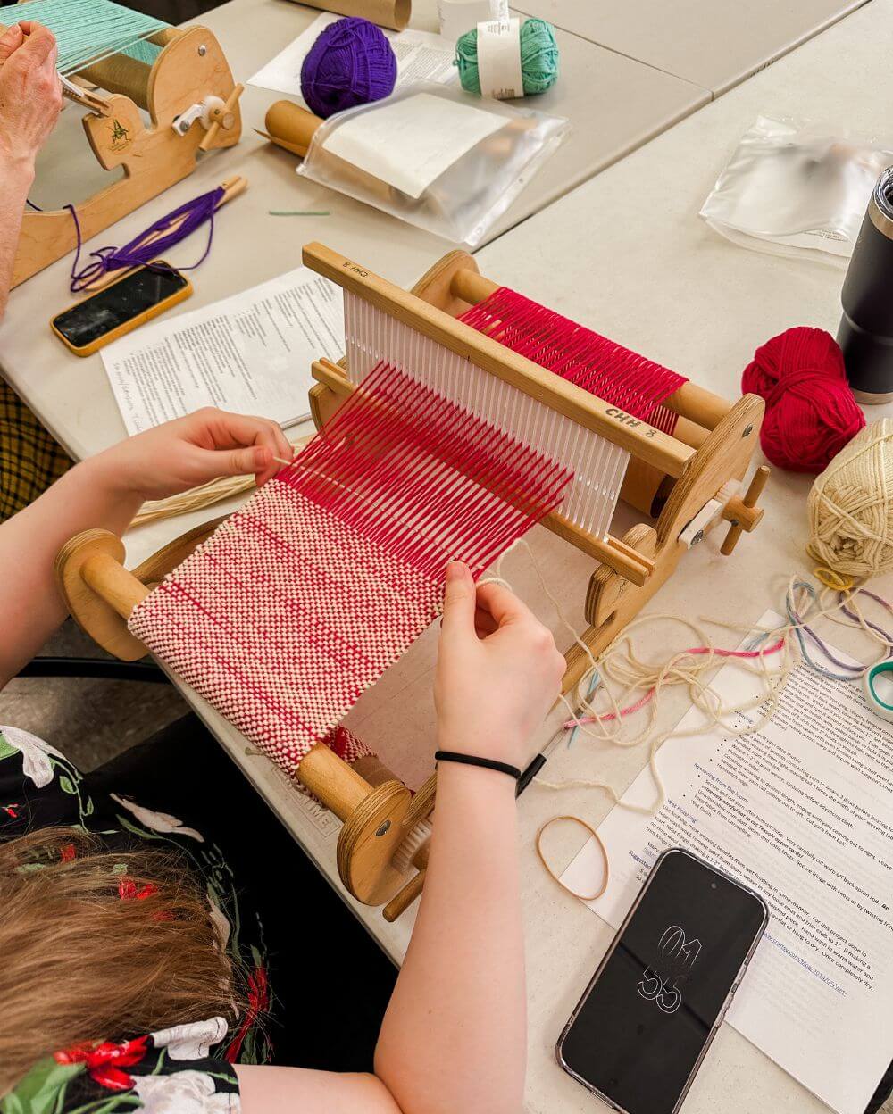 woman weaving on rigid heddle loom