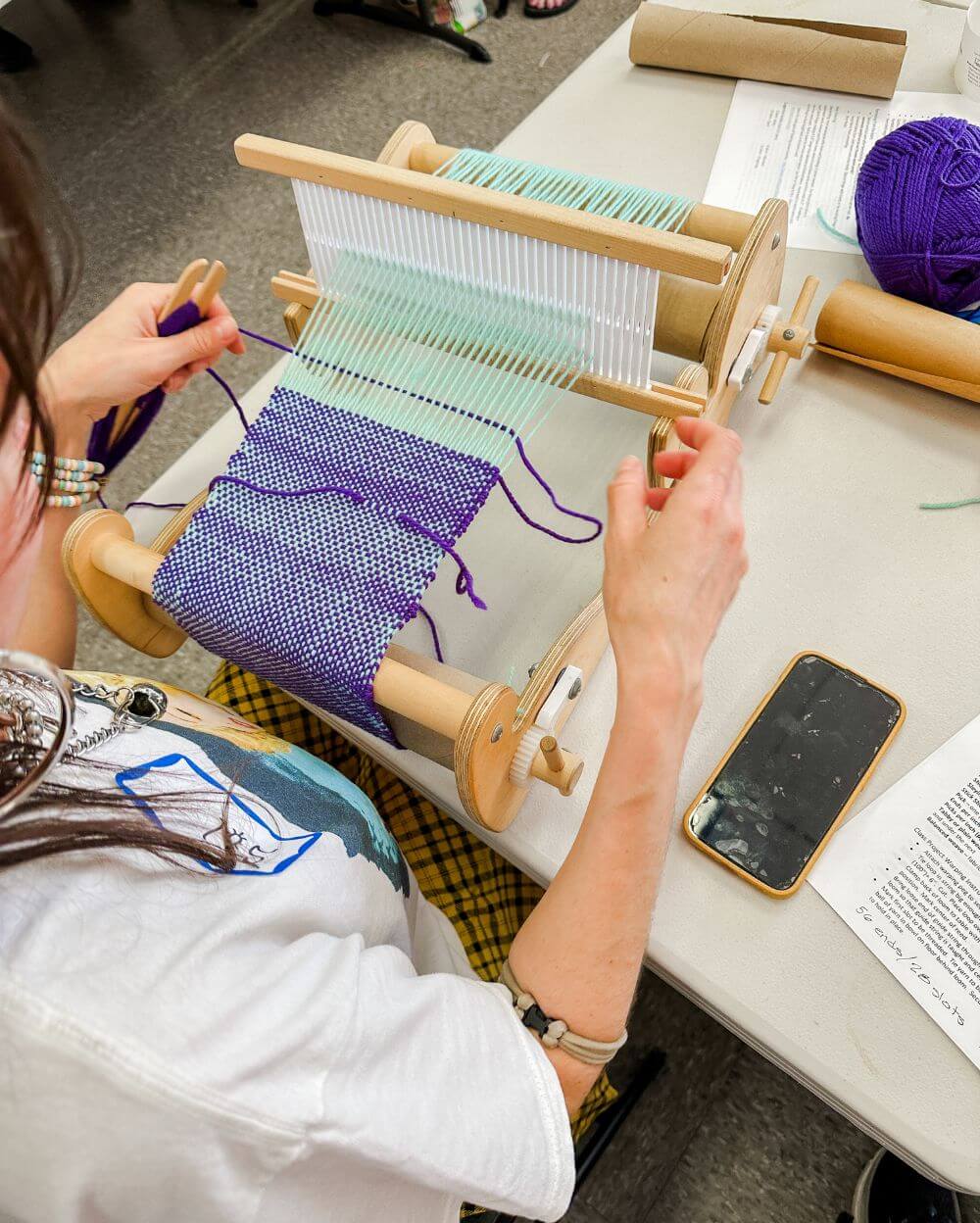 woman weaving on rigid heddle loom